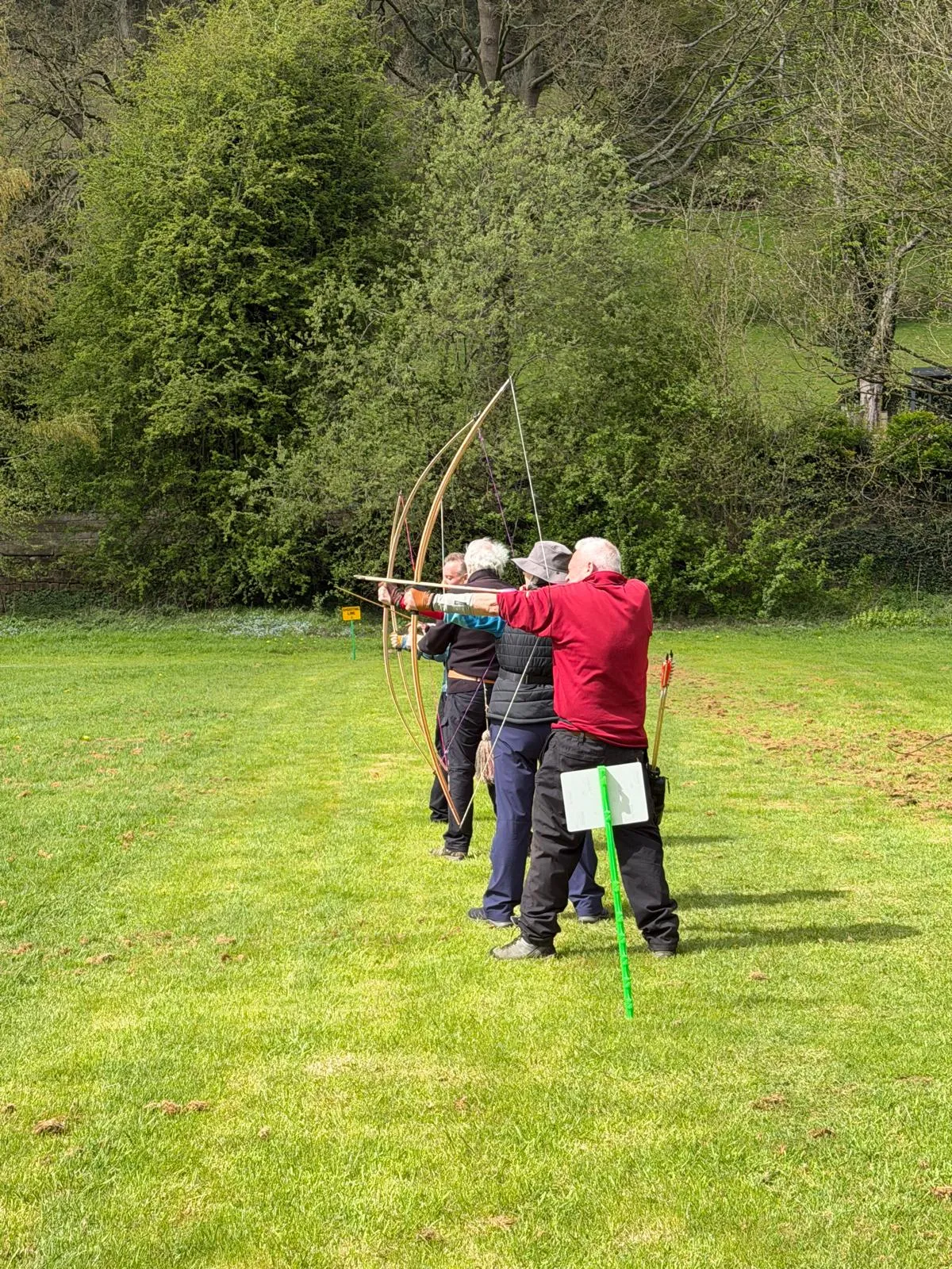 Aequus Archers longbow archers shooting together on the line